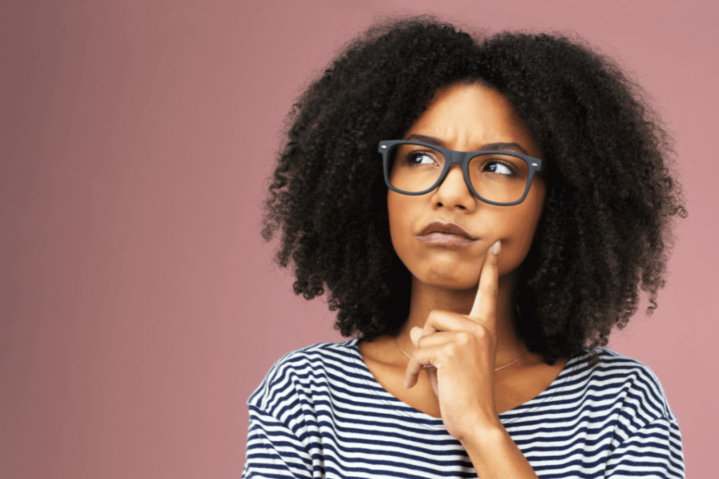 woman wearing glasses wondering thinking inquisitively